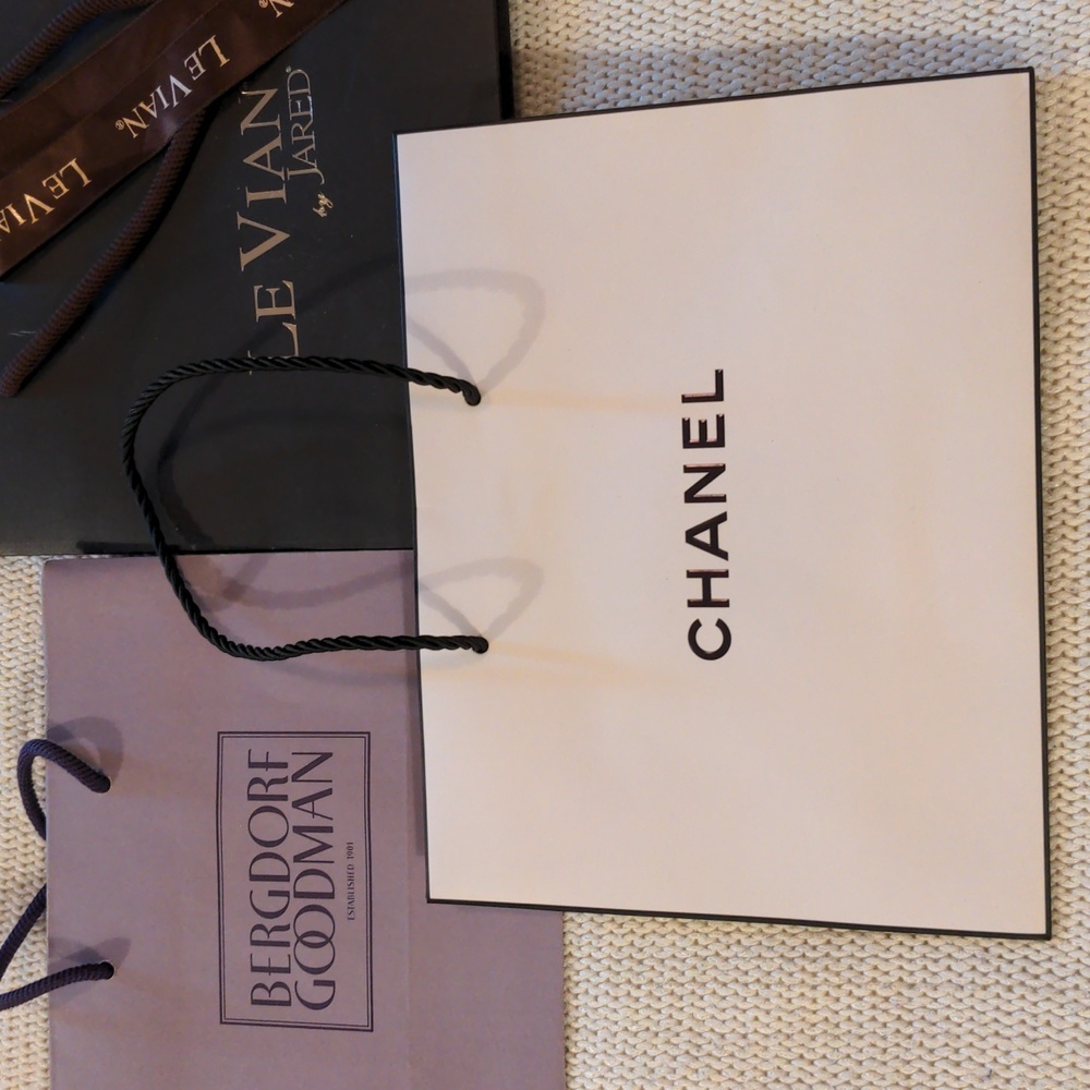 3 shopping bags Chanel, Bergdorf Goodman, and Le Vian by Jared